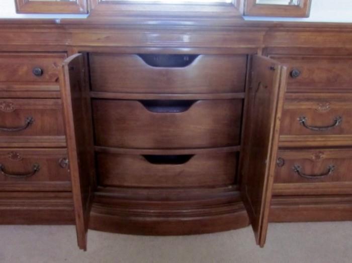Triple dresser with Burlwood veneer, 6 drawers plus 3 additional drawers behind double doors, brass hardware, 3-section beveled mirror with adjustable sides.