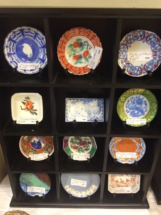 Collection of miniature plates in display cabinet