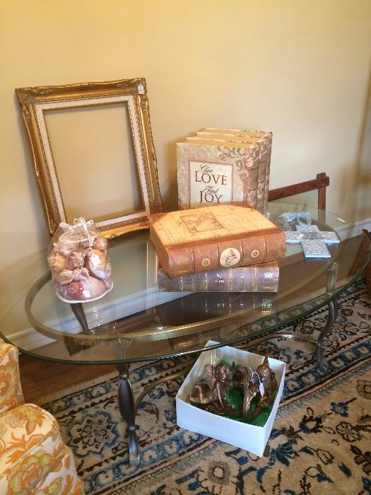 Oval glass top coffee table has 2 matching end tables.