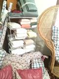 Custom bedding, material to match, and other linens; one of two rattan "queen" chairs