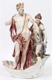 Lot#1003, MEISSEN PORCELAIN MYTHOLOGICAL FIGURE GROUP, H 16 1/2", W 11", NEPTUNE WITH NEREID.Modeled as Neptune standing within a shell base, a Nereid, possibly his wife Salacia, stands beside him; the unglazed base is marked with blue crossed swords (see additional photo).  Measures H.16 1/2" x 11" x 7". From the collection of Dr. Marion Scott and Ann Scott, Grosse Pointe Shores.