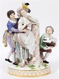 Lot#1004, MEISSEN PORCELAIN FIGURE GROUP, LATE 19TH C., H 12 1/2", W 8", 'LUST'Modeled as a young man encircling the waist of a young woman with exposed breast, her left elbow rests atop a column, a fallen column at her feet, off to the side a kneeling man holds a pair doves in a hat, an attribute of Lust; marked in blue under glaze with crossed swords and incised F 60 (see additional photo).  Measures H.12 1/2" x 8" x 5 1/4". From the collection of Dr. Marion Scott and Ann Scott, Grosse Pointe Shores.