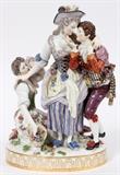 Lot#1005, MEISSEN PORCELAIN FIGURE GROUP, LATE 19TH C., H 12 1/2", W 8", 'ENVY'En suite with preceding figure group, modeled as a young man wooing a young woman, another woman, an allegory of Envy, is seated on a rock alongside, apparently weeping and shielding her eyes from the pair of lovers; marked in blue under glaze with crossed swords and incised F 49 (see additional photo).  Measures H.12 1/2" x 8" x 5 1/4". From the collection of Dr. Marion Scott and Ann Scott, Grosse Pointe Shores.
