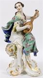 Lot#1002, MEISSEN PORCELAIN FIGURE OF A MUSE, C. 1930, H 16", W 9", 'ERATO'The Muse of lyric and love poetry is depicted seated on an acanthus scroll base, partially draped, playing a lyre; marked in blue under glaze with crossed swords and impressed 369/7 and 122 (see additional photo).  Measures H.16 1/4" x 9" x 7 1/2". From the collection of Dr. Marion Scott and Ann Scott, Grosse Pointe Shores.