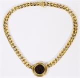 Lot#1044, 18KT YELLOW & WHITE GOLD LINK & BYZANTINE COIN NECKLACE, L 18"Having a Cuban linked 18kt yellow and white gold chain, featuring a Byzantine coin pendant, Dia.1 1/4".  Weighing approximately 77.7 grams.