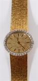 Lot#1047, CONCORD .75CT DIAMOND & 18KT YELLOW GOLD LADY'S WRISTWATCH, L 6 1/2"A Concord ladies watch, circa 1970.  Having a two piece case set with 36 round brilliant cut diamonds of .75ct, fitted to an integrated Florentine finished 18kt yellow gold band.  With a Swiss quartz movement and a face having matching textured yellow gold dial with applied stick indexes.  Model number 379497, and #379497.  Weighing approximately 57.1 grams.