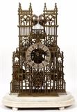 Lot#1064, ENGLISH TRIPLE FUSEE BRASS CATHEDRAL SKELETON CLOCK, 19TH C., H 21", W 13", UNDER A GLASS DOME.Pierced brass cathedral shape clock in the style of Westminster Abbey, triple fusee, drop hammer strike on eight bells, measuring H.21 3/8" x 13" x 6 1/2", having a 6" silvered chapter ring with incised Roman numerals, mercury pendulum and two keys, raised on a white marble base under a glass dome, H.27" x 16" x 9" overall.  Labeled in two places at the front of the clock, "W. F. Evans & Sons, Fecit" and "Soho Clock Factory, Handsworth".
