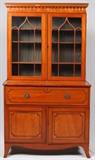 Lot#1067, IRISH INLAID MAHOGANY SECRETARY BOOKCASE, CIRCA 1890-1920, H 86", W 49", D 23"Featuring an upper section with two glass doors and two shelves.  The lower section also has two doors and a faux drawer which opens to reveal a green tooled leather top writing surface, six drawers and nine pigeon compartments.