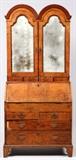 Lot#1068,ENGLISH BURL WALNUT, ELM & OAK SECRETARY, 18TH C., H 42", W 36"Having two upper mirrored doors with arched top opening to three shelves with the upper shelf tucked under the arched top, all  above four narrow drawers. The lower section houses the slant top which opens to eight pigeon holes flanking a small hinged center cabinet door. Also four small narrow drawers. Writing surface has a door opening to a stationary storage compartment. Tooled leather on writing surface on the underside of slant top. Brass hinges and latch. Two half width drawers and two full width drawers finish off the bottom of the piece. All supported by bracket feet. The top cabinet measures H.42" x 36" x 11" and the base measures H.40" x 36" x 17".