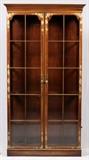 Lot#1088, MAHOGANY & GILT STENCILED DISPLAY CABINET, H 85", W 42", D 12"Probably Baker Furniture Co., fitted with a pair of doors having beveled glass panels, opening to four glass shelves.