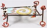 Lot#1102, DALE WEDIG, MODERN IRON BENCH, W 24"Multicolor, with a central swirl design. Dale Wedig just completed his 30th year as a professor of Art and Design at Northern Michigan University where he teaches blacksmithing, sculpture, jewelry, and other core classes.  Measures H.4" x 23" x 24".