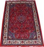 Lot#1124, SAROUK PERSIAN RUG, 4' 10" X 3' 4"Red ground with light blue corners, overall flowering pattern, within an ivory border.