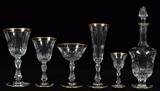 Lot#1167, ST. LOUIS 'LOZERE GOLD' CUT CRYSTAL STEMWARE, 54 PIECES..Including 12 goblets/burgundy wines, H.6 1/2", 12 white wines, H.5 1/2", 11 fluted champagnes, H.7 1/2", 12 sherbets/saucer champagnes, H.4 3/4", 6 cordials, H.3 3/4", and 1 decanter, H.9 3/4"; each piece has a cut bowl on a paneled stem, with gold bands about the rims, acid etched signature underneath.  Pattern STL23.