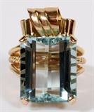 Lot#1226, 7.86CT NATURAL AQUAMARINE & 14KT YELLOW GOLD RING, SIZE 3 3/4.Having a 7.86ct natural aquamarine set amongst a retro style mount in 14kt yellow gold.  Measuring H.3/4" x W.1/2".  Weighing approximately 7.2 grams.