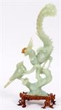 Lot#1297, JADE SCULPTURE OF BIRDS, H 11 1/2"Two birds on tree bough, largest with exotic long tail, sparrow on lower branch. Height 11.5" plus wood base.
