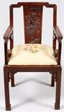Lot#1371, CHINESE HAND CARVED TEAKWOOD ARMCHAIR..Heavily carved back panel. H 36" W 20". Circa 1900. Upholstered pad seat.