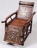 Lot#1373, ROSEWOOD & MOTHER-OF-PEARL RECLINING CHAIR, H 37", L 24", D 42"Oriental reclining chair, embedded with hundreds of carved mother of pearl symbols.