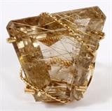 Lot#22, 70.0 CT RUTILATED QUARTZ RING, C.1970, H 1 1/4", W 1 1/4", SIZE 7 1/2.Featuring a 70.0ct rutilated quartz, faceted trapezoid shape.  Set in a hand made wire metal frame.  Weighing approximately 21.5 grams.