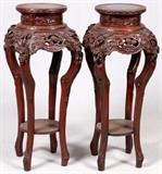 Lot#29, CHINESE TEAKWOOD STANDS, 19TH C., PAIR, H 42", DIA 17"Each with a pierced apron featuring prunus blossoms, cabriole legs joined by a shelf stretcher.