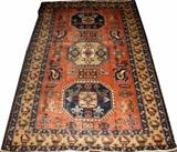 Lot#43, DAGESTAN HAND WOVEN RUG, C. 1900 W 55", L 84"Having an orange ground, three borders and three equally spaced medallions of geometric design. Animal designs in the primary border.