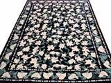 Lot#46, CHINESE HAND WOVEN WOOL RUG, W 8' 10", L 11' 10"Chinese hand woven wool rug having a navy ground, 1 wide border with two guard borders with diamond designs. Green and white flowers throughout the primary border and field.