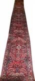 Lot#50, SAROUK HAND WOVEN WOOL RUNNER, C. 1940, W 2' 7", L 21' 2"Having three borders, dark burgundy field with overall floral and leaf design in pink, blue, green and ivory.