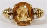 Lot#67, LADY'S 18 KT GOLD, CITRINE AND DIAMOND RING..An 18 KT yellow gold ring featuring a central citrine flanked by four diamonds. 4.3 grams total wt. Size 5.5.