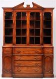 Lot#113, KITTINGER MAHOGANY SECRETARY BREAKFRONT, 1940S, H 87", W 60", D 18"Having an open pediment at the crest, above glass framed cabinet doors opening to three shelves. Bottom of cabinet has four center drawers flanked by two drawers above two cabinet doors. All having hanging brass pulls. Wide molding along the bottom.