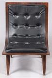 Lot#127, CARTER BROS. WOOD FRAME SWOOP CHAIR,A Mid-Century piece having a laminated wood frame and legs with black "vinylare".  Manufactures label identifies the chair as Style 7010 5-43. Turned and tapered legs with brass disc feet.