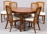 Lot#126, OAK CHINESE INFLUENCE DINING TABLE AND CHAIRS, 8 PIECES, H 29", DIA 40"Having a parquet pattern on the top, one 20" leaf. Brass angled trim at top of legs, below top. Bamboo shape to legs. Six side chairs with cane back and upholstered seats. Straight front legs.
