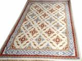 Lot#217, INDIAN DHURRIE, HAND WOVEN WOOL RUG, W 8', L 10' 5"Having a flat weave, cream ground, five borders, with geometric shapes in the primary border, guard borders in brown blue and red. Diamond shape medallions throughout the field.