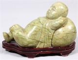 Lot#233, CARVED JADE RECLINING FIGURE, H 14", L 23"Reclining figure on a teakwood base.