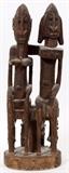 Lot#312, AFRICAN CARVED WOOD DOUBLE FIGURE, H 17"Male and female seated figures with male figure having arm around the other's shoulder.