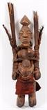 Lot#317, AFRICAN CARVED WOOD, FEATHER & BRANCH FIGURE, H 17"A figure carrying branch bundles accented by feathers.