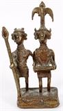 Lot#320, AFRICAN BRONZE DOUBLE FIGURE, H 7", W 3"Double bronze figure of two holy men wearing costumes one holding a spear and arm around other man wearing an elaborate headress. On an integral square base.