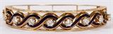 Lot#2059, 2.50CT DIAMONDS, ENAMEL & 14KT YELLOW GOLD BANGLE BRACELET, C.1960,A Victorian style bangle set with 8 round brilliant cut diamonds of graduated size, weighing 2.50ct, set amongst a waving blue enamel accent in 14kt yellow gold.  Weighing approximately 30.7 grams.