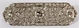 Lot#2060,  5 1/2 CT. DIAMOND AND PLATINUM BROOCH,Circa 1920; center diamond 0.57 ct., J-K color, VS1 clarity; two diamonds at 3/8 ct., color G-H,  VS1; 66 diamonds at 1/16 ct. each.