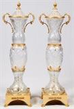 Lot#2072, D'ORE BRONZE AND CUT CRYSTAL STANDING PALACE URNS WITH HANDLES PAIR H 4' 8" DIA 17"13" x 13" base. Various designs throughout crystal. Mid  to late 20th century.