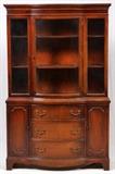 Lot#2243, MAHOGANY CHINA CABINET, H 70", W 44 1/2", D 15 1/4"The upper section features a central glass door that reveals two full-length shelves.  The lower section has three drawers that are flanked by doors that reveal a single shelf.