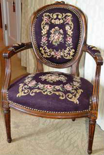 Louis XVI style armchair with needlepoint upholstery. Late 19th century. Walnut frame. Needlepoint in very good condition