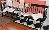 Antique deacons bench in black paint - shown with antique linens