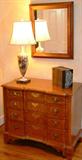 Oak blockfront chest of drawers with hand painted Victorian glass lamp, leather bound VOL of books, oak framed mirror.