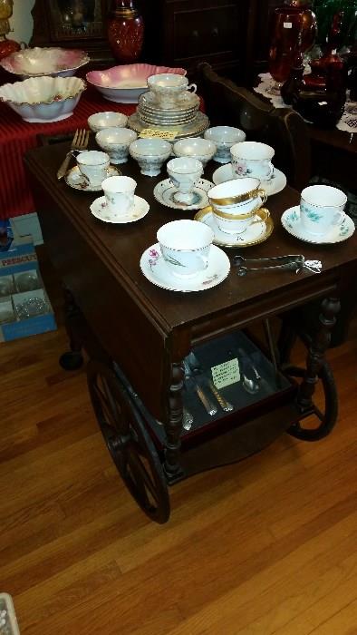 Antique tea cart.  Lots of tea cups