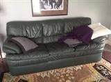 Green leather sofa.  High end rug from India