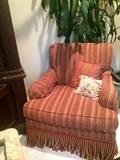 One of two striped club chairs in red & gold; real corn plant