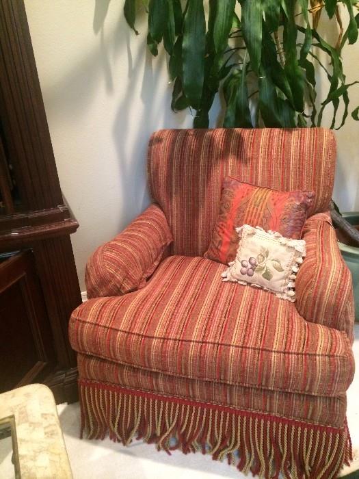 One of two striped club chairs in red & gold; real corn plant