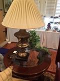 One of two brass lamps; round end table