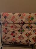 One of three quilt racks; vintage quilt