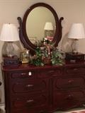 Dresser with adjustable oval mirror