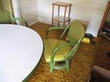 funky green chairs surround large round white table